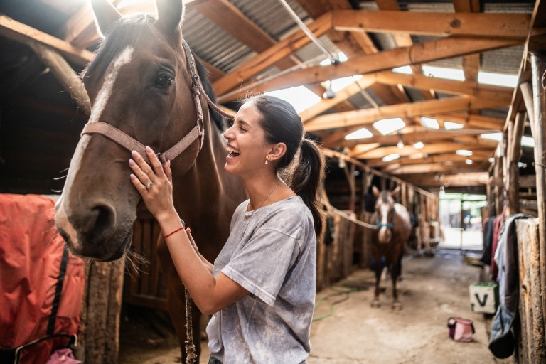 woman petting horse