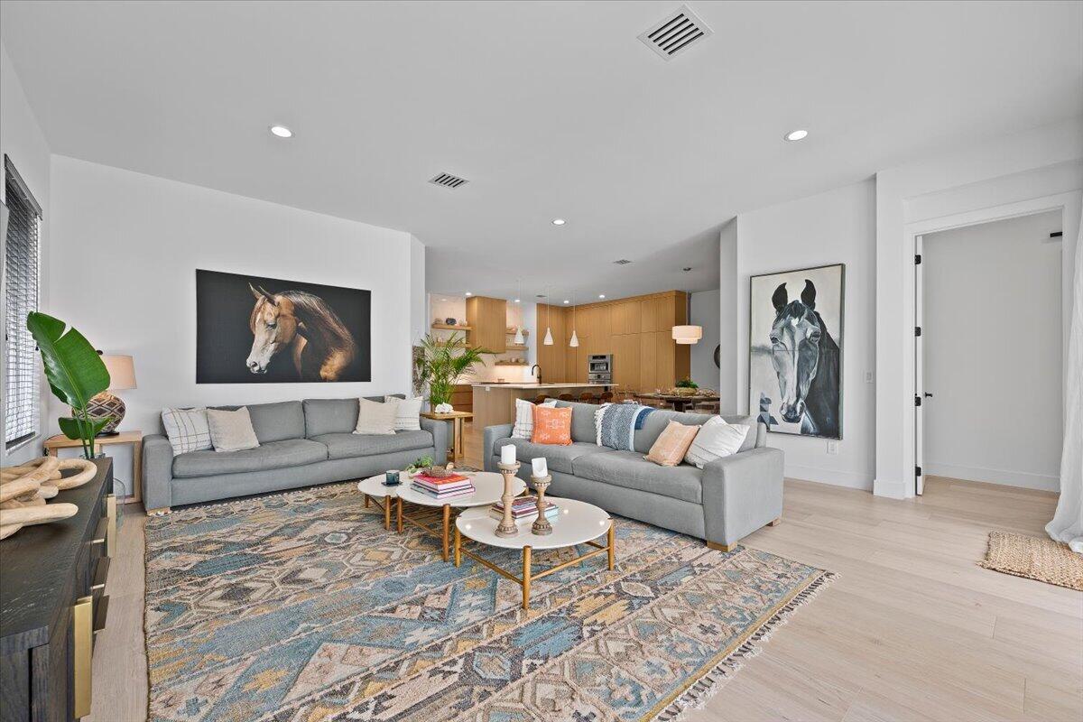 Bright living room with seating and an open kitchen